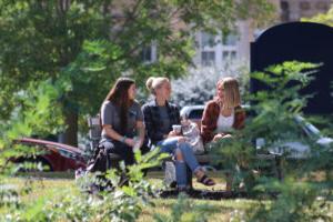 Smiling students on bench by the lake